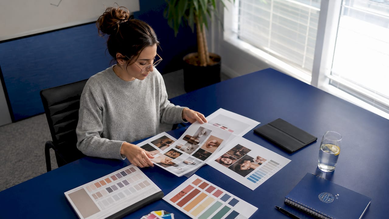 Marketing strategist reviewing cosmetic campaign materials