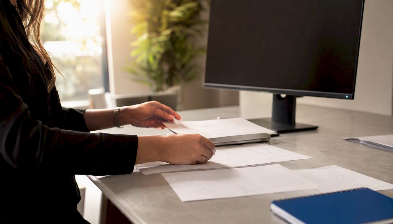 Hands arranging med spa marketing documents