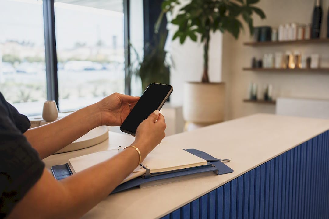 Hands with smartphone and appointment book