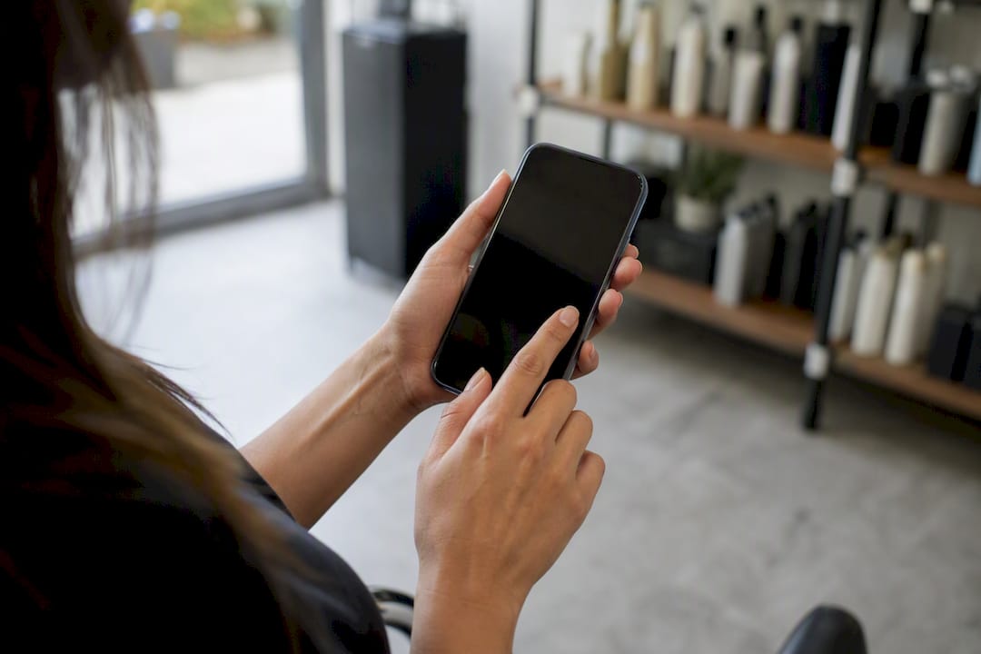 Hands tapping booking button on smartphone