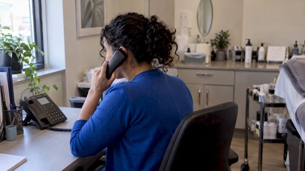 Salon coordinator handling a booking phone call